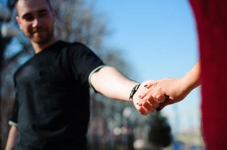 Young beautiful couple in love posing outdoor in city. Young woman smiling with her handsome man.