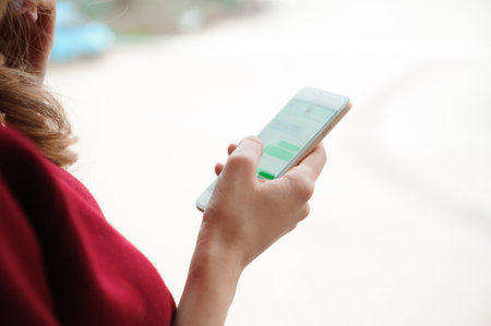 beautiful business woman writing sms on a mobile phoneの写真素材