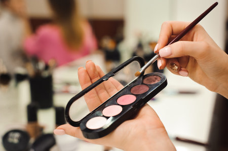 makeup brush, products in hands, closeup photoの写真素材