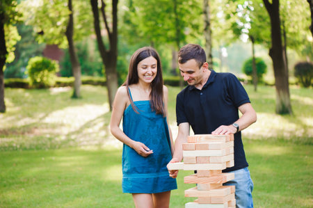 side view of men and women playing game in a park