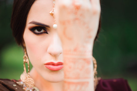 Mehndi covers hands of beautiful Indian womanの写真素材