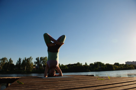 Healthy woman lifestyle balanced practicing meditate and energy yoga on the bridge in morning the nature.の写真素材