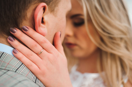Portret of happy young couple hugging on the edge of the mountain.の写真素材