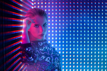 Disco dancer in neon light in night club. Fashion model woman in neon light