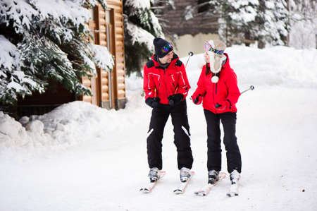 Skiing, snow, winter fun, happy family is skiing in the forest.の写真素材