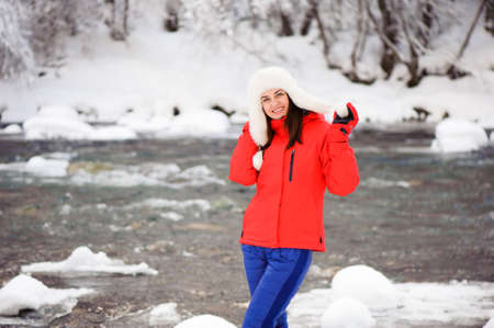 Young beautiful girl in the winter forest near the riverの写真素材