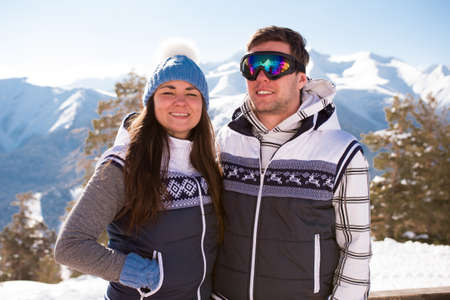 Young people take a rest after skiing in the mountains, winter time.