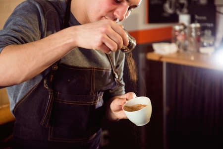Coffee Latte Barista making pattern in a cup of coffee shop.
