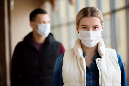 Concept of coronavirus quarantine. MERS Cov, Novel coronavirus, man and woman with medical face maskの写真素材