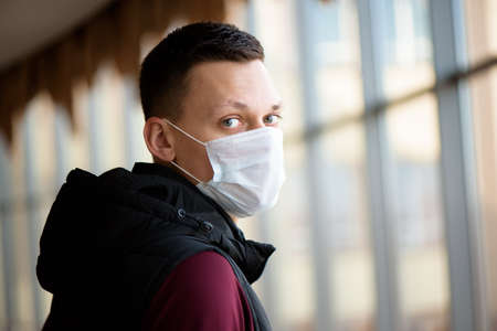 Sick man wearing a face mask in quarantine zone.