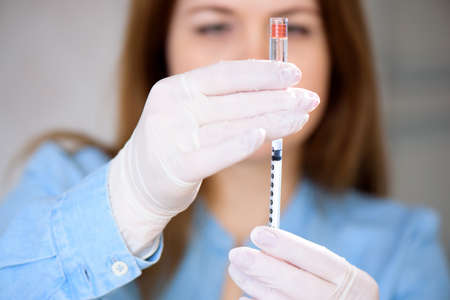A doctor makes a  vaccine at a hospital.