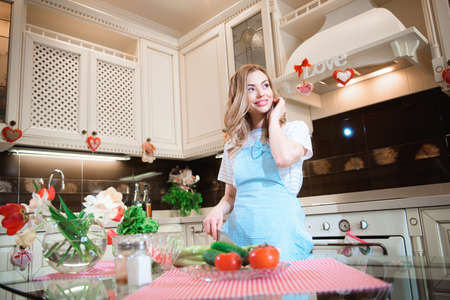 Young woman in the kitchen preparing a saladの写真素材