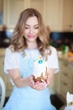 Happy easter. A mother with cakes in her hands prepares for Easter.の写真素材
