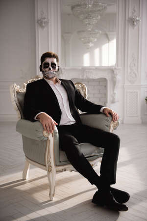 Man with a terrible make-up on white room background.の写真素材