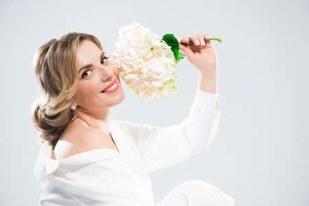 Glamour portrait of beautiful woman model with fresh daily makeup and romantic wavy hairstyle.の写真素材