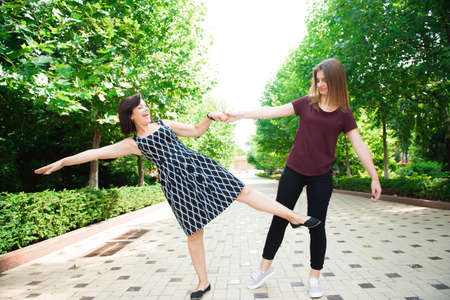 Mother With Adult Daughter In Park Together.の写真素材