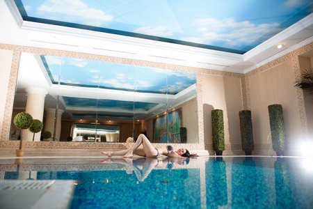 Beautiful young woman relax around swimming pool in hotel resort for leisure in vacation.の写真素材