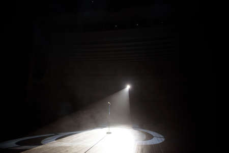 Microphone in a smoke on a dark background in the beam of light.の写真素材