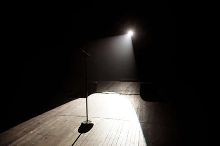 Microphone in a smoke on a dark background in the beam of light.の写真素材