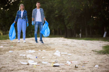 Diverse Group of People Picking Up Trash in The Park Volunteer Community Service.の写真素材