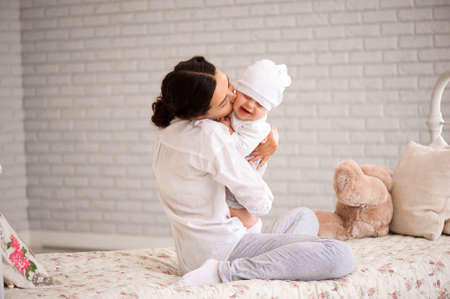 Mother, playing with her toddler boy smiling.の写真素材