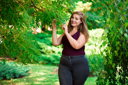 Single Young Pretty Plus Size Caucasian Happy Smiling Laughing Girl Woman, Walking In Summer Green Forest. Fun Enjoy Outdoor Summer Natureの写真素材