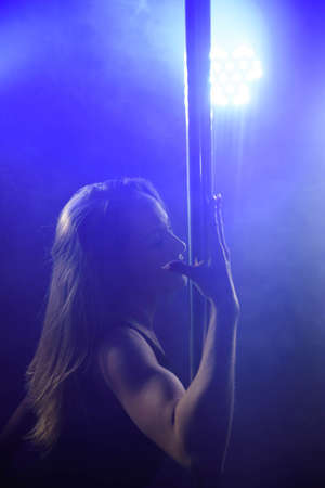 An attractive sexy woman pole dancer performingの写真素材