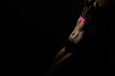 Close up of young slim female stomach near the pole.の写真素材