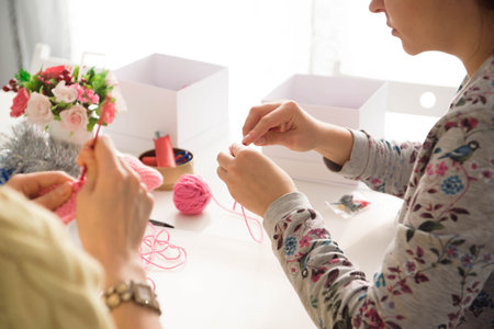 Young attractive girls in a knitting lessonの写真素材