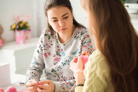 Young attractive girls in a knitting lessonの写真素材