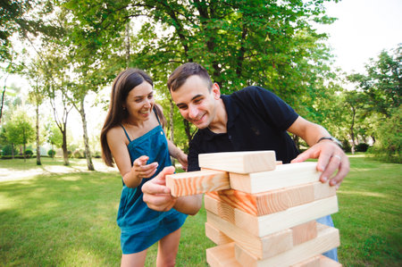side view of men and women playing game in a park.の写真素材