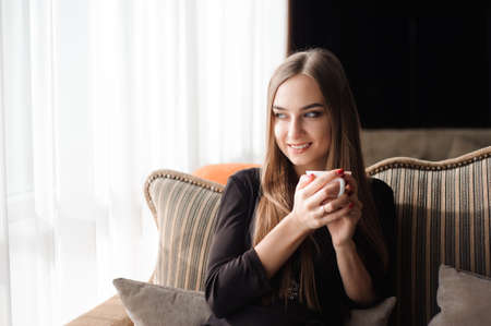 woman drinking coffee in the morning at a restaurantの写真素材
