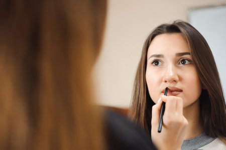 Makeup artist creating beautiful makeup for brunette model.の写真素材