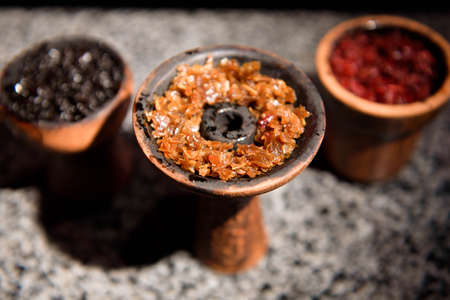 Clay bowl for hookah with tobacco and accessories for making hookah.の写真素材