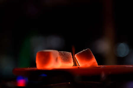 Shisha hookah with red hot coals. Modern hookah with coconut charcoal for relax and shisha smoke. Hookah and sparks from coals.の写真素材