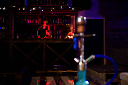 Hookah on the background of a bar, light, smoke, smog