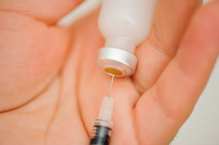 Girl picking up insulin in a syringe close-up. Diabetes.の写真素材