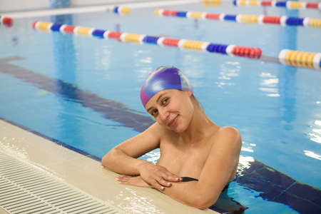 Beautiful pregnant woman happy smiling in swimming pool.