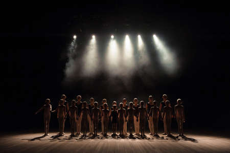 a large group of children have a reverence at the end of the performanceの写真素材