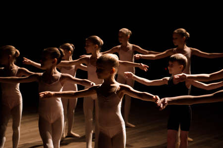 A large group of children rehearsing and dancing the ballet.