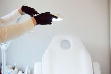 Interior of a cosmetology office.Modern equipment of cosmetology.White chair for cosmetology procedure.の写真素材