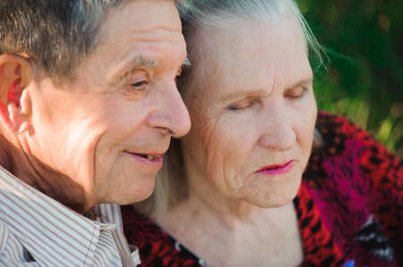 Beautiful happy eighty years old people sitting in the park.