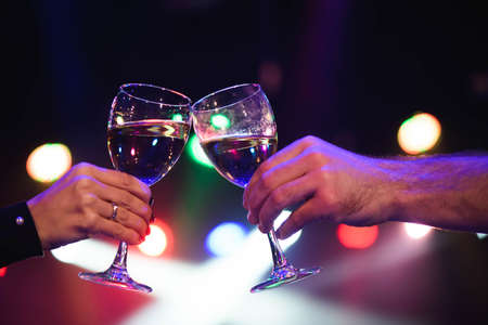 Cheerful couple clinking glasses of champagne at the party.の写真素材