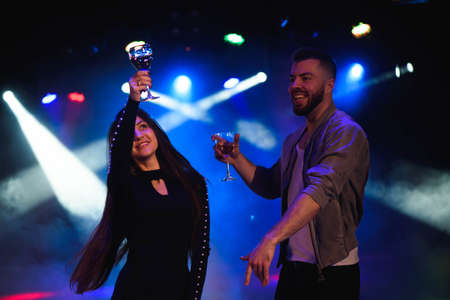 Young stylish couple flirting in the nightclub.の写真素材