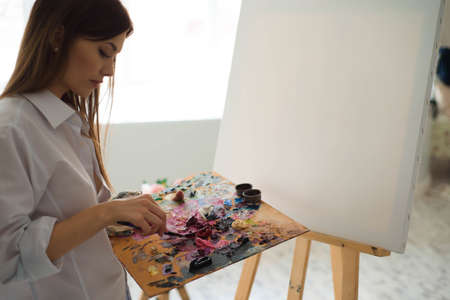 Young female student having classes at art studio, learning how to draw flowers.の写真素材