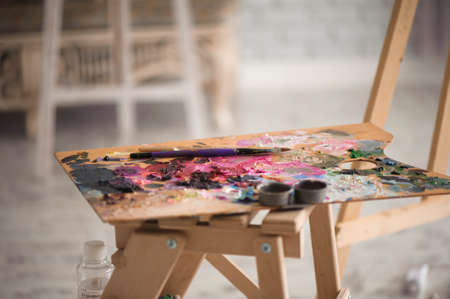 Artists brushes and oil paints on wooden palette.の写真素材