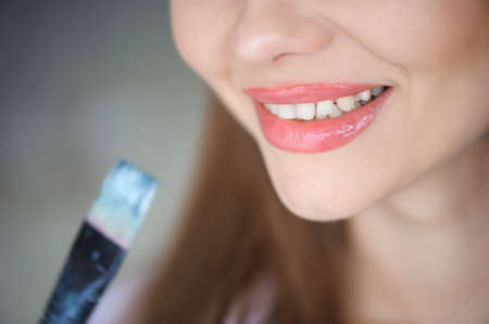 Close up view of female artist painting pictureの写真素材
