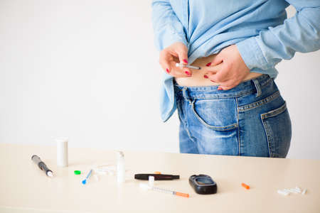 Diabetes patient insulin shot by syringe with dose of lantus, su