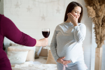 No alcohol during pregnancy. Young pregnant woman refuses to drink wine.の写真素材