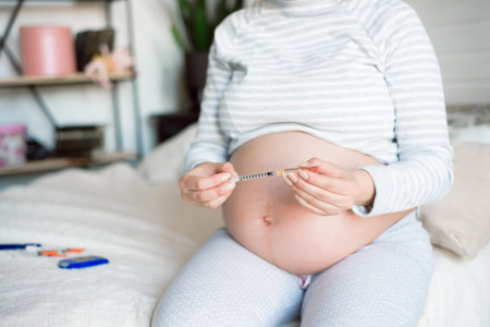 Diabetes of pregnant, insulin pen. Pregnant woman with syringe.の写真素材